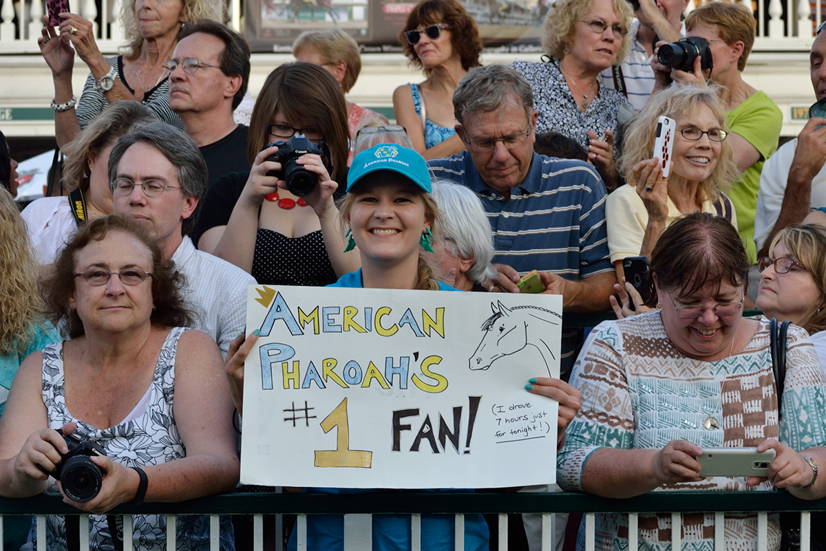 Fans line the paddock fence for American Pharoah