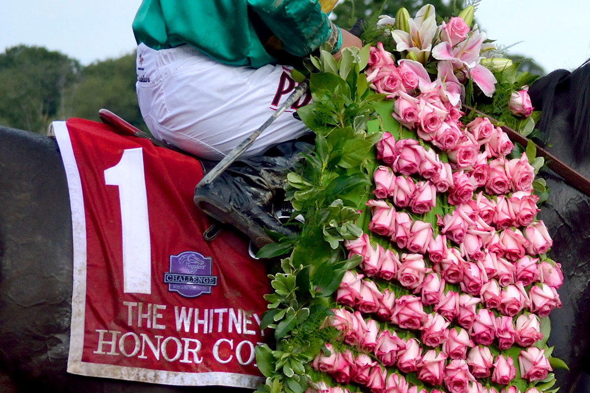 Honor Code wears the Whitney winner's garland of Marylou roses